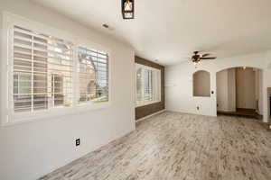 View from dining area into Livingroom. Large windows with Plantation Shutters.