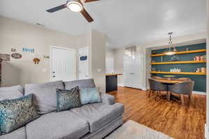 Living room featuring ceiling fan and hardwood / wood-style floors