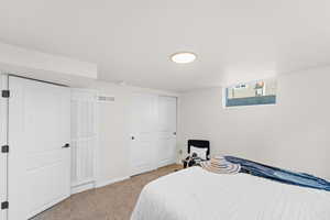 Bedroom with light colored carpet