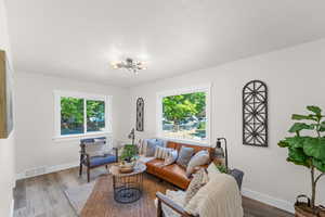 Living room with an inviting chandelier and hardwood / wood-style flooring