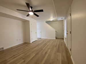 Additional living space featuring ceiling fan and light hardwood / wood-style flooring