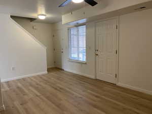 Entryway featuring ceiling fan and light hardwood / wood-style floors