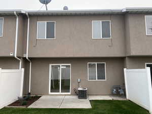 Rear view of house featuring a patio area and central AC