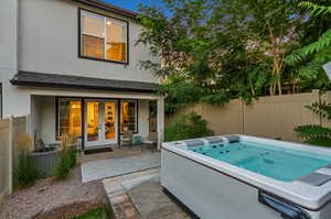 View of swimming pool featuring a patio area, a hot tub, and french doors