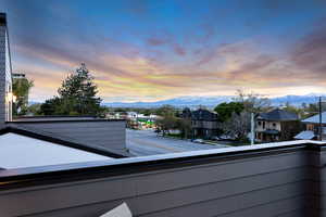 Balcony at dusk featuring a mountain view