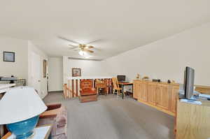 Home office featuring light carpet and ceiling fan