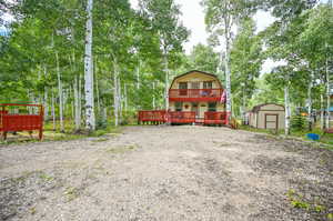 View of yard featuring a storage shed and a deck