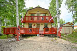 Exterior space featuring a storage shed and a deck