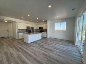 Kitchen with included stainless steel refrigerator.