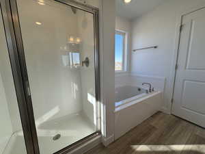 Grand Primary Bath featuring separate tub and shower