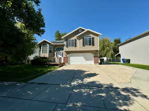 View of front of home featuring a garage and a front yard