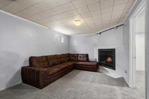 Carpeted living room featuring ornamental molding