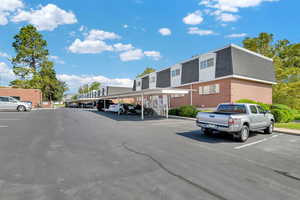 View of parking featuring a carport