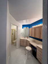 Main bathroom, shower, sink #1 and lots of cabinetry and counter space with lighting