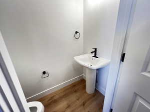 Bathroom featuring toilet and hardwood / wood-style floors