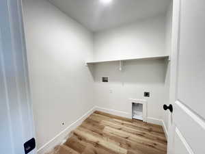 Clothes washing area with light hardwood / wood-style floors, electric dryer hookup, and hookup for a washing machine