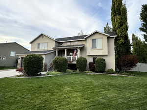 View of front of property featuring a porch and a front lawn