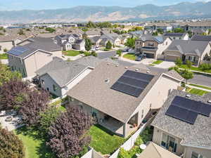 Back of house featuring private backyard and solar panels.