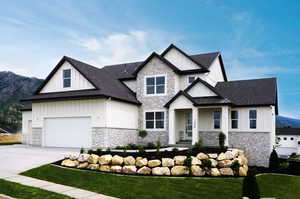 View of front facade with a garage and a mountain view