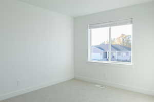 Spare room with light colored carpet