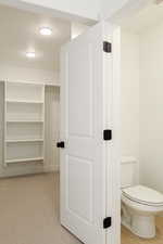 Bathroom featuring a textured ceiling and toilet