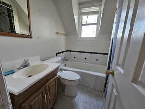 Bathroom with vanity, toilet, and a bath