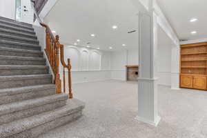 Stairway featuring carpet floors and ornate columns