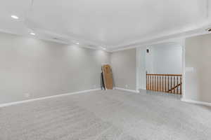 Unfurnished room featuring a tray ceiling, crown molding, and carpet