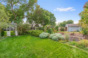 View of yard featuring a storage unit and a gazebo