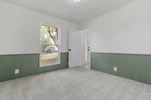 Unfurnished room featuring carpet