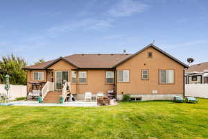 Back of house featuring a patio area, a yard, and a pool