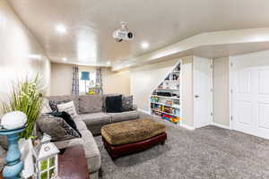 Living room with carpet floors and a textured ceiling