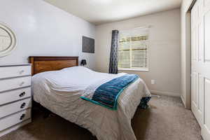 Bedroom featuring a textured ceiling and carpet floors