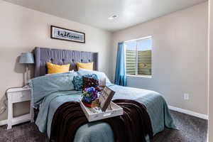 Carpeted bedroom featuring a textured ceiling