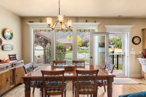 Dining space featuring a notable chandelier and light hardwood / wood-style floors