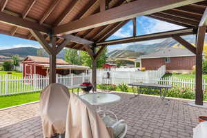 View of patio featuring a mountain view and a storage unit