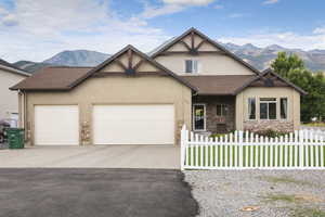 View of front of home with a mountain view and a garage