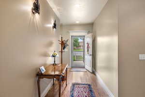 Doorway to outside featuring wood-type flooring