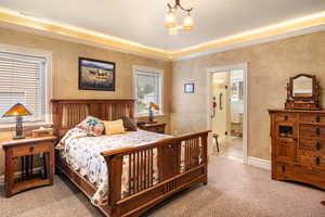 Bedroom featuring a chandelier and carpet flooring