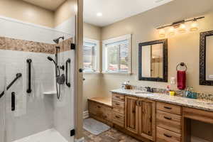 Bathroom with vanity and a shower with shower door