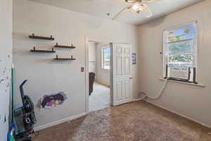 Interior space featuring cooling unit, ceiling fan, and carpet floors