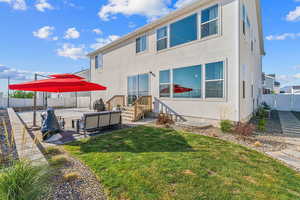 Back of property featuring a lawn and a patio area