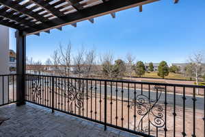 Balcony featuring a pergola