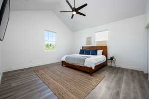 Bedroom with high vaulted ceiling, ceiling fan, and wood-type flooring