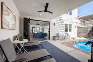 View of patio featuring ceiling fan and a swimming pool