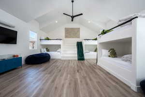 Unfurnished living room with vaulted ceiling, ceiling fan, and light hardwood / wood-style floors