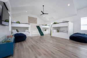 Living room with light wood-type flooring, lofted ceiling, and ceiling fan