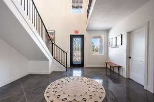 Foyer entrance featuring a textured ceiling