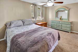 Carpeted bedroom with ceiling fan