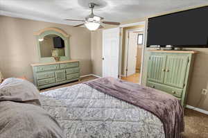 Bedroom with a textured ceiling and ceiling fan